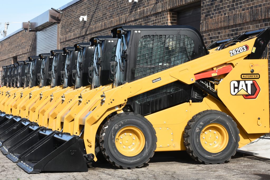 A bunch of excavators kept in line together