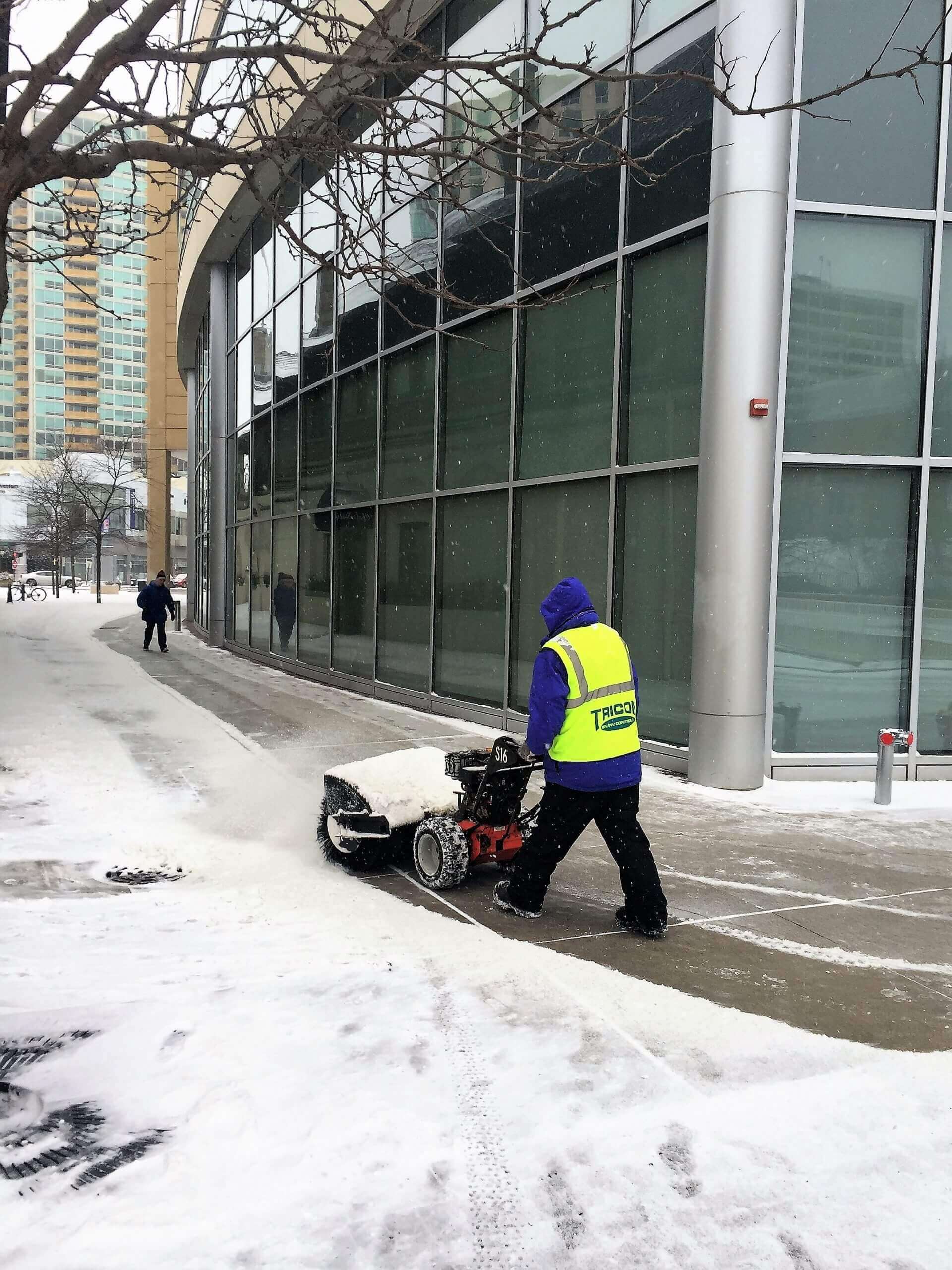 A person removing snow from the road